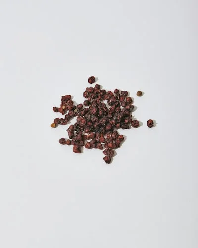 Dried juniper berries on a light background